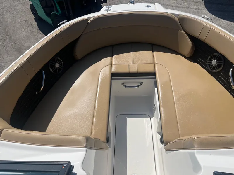 Slide: The Image of 2024 Sea Ray SPX 230 Outboard boat interior with tan seating and stainless steel accents. - 11