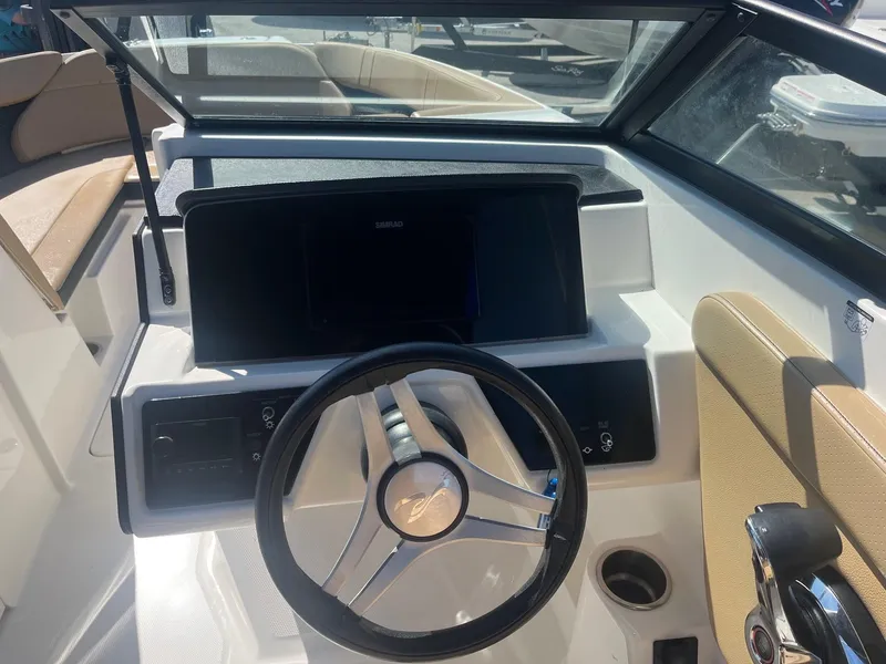 Slide: The Image of 2024 Sea Ray SPX 230 Outboard dashboard with steering wheel and control panel. - 6