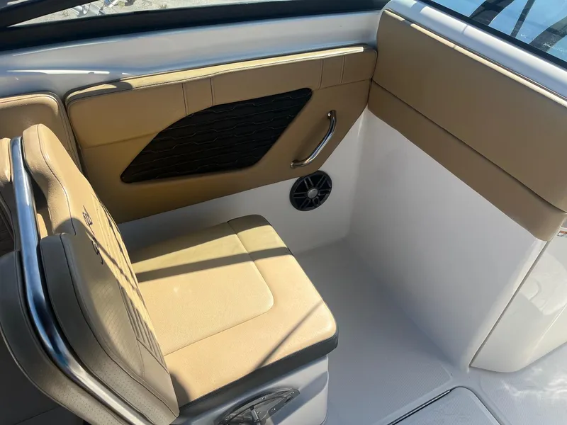 Slide: The Image of 2024 Sea Ray SPX 230 Outboard interior seating with tan upholstery and sleek design. - 8