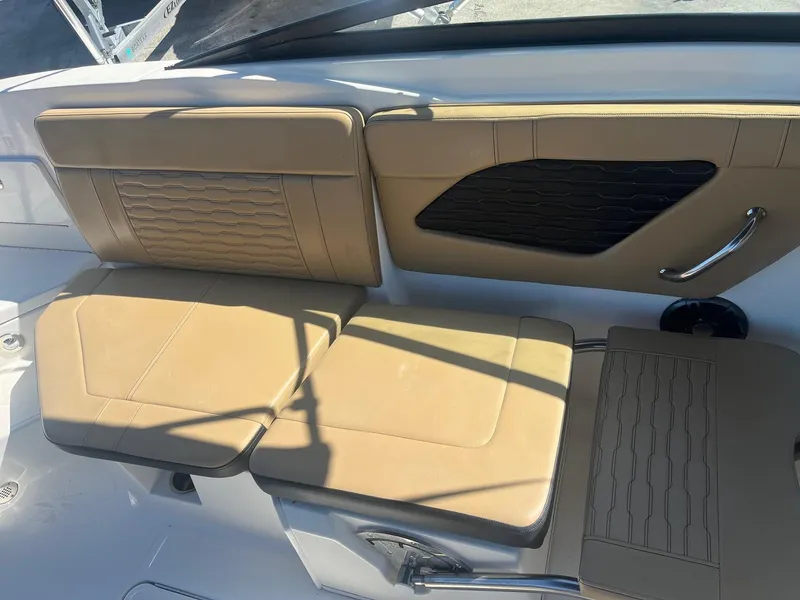 Slide: The Image of 2024 Sea Ray SPX 230 Outboard boat interior with tan seating and modern design. - 9