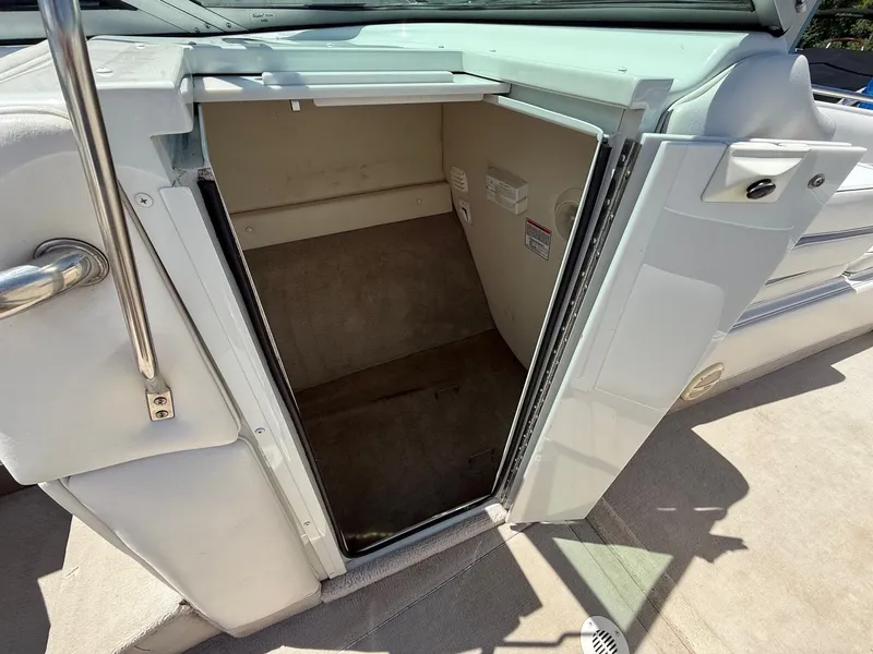 Slide: The Image of Open storage compartment on a 2004 Crownline 266 BR boat. - 13