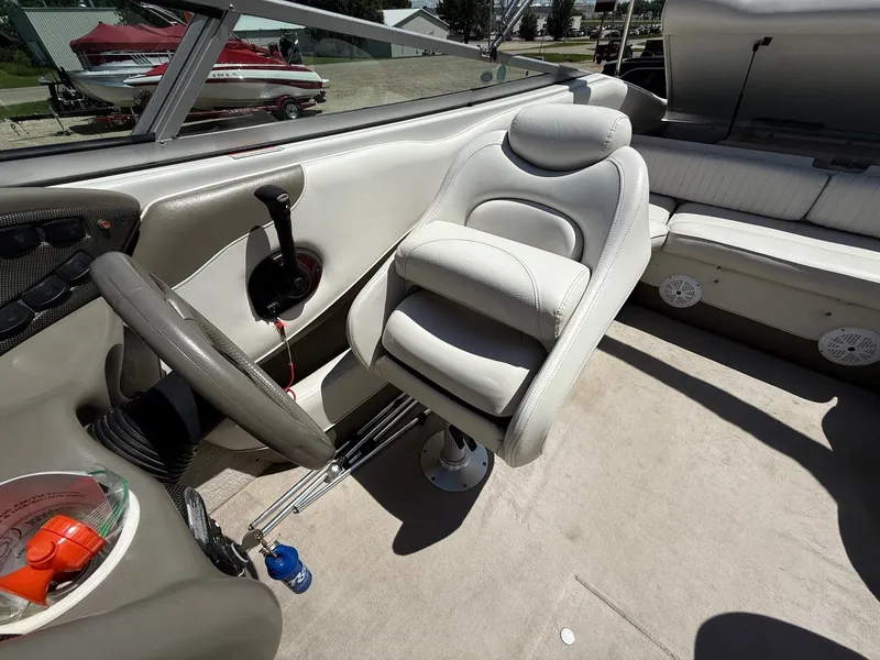Slide: The Image of Interior of 2004 Crownline 266 BR boat with steering wheel and seating. - 17