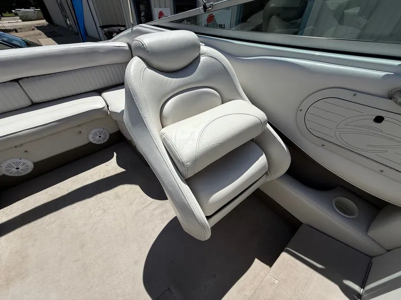 Slide: The Image of 2004 Crownline 266 BR boat interior with white leather seating and cup holder. - 18