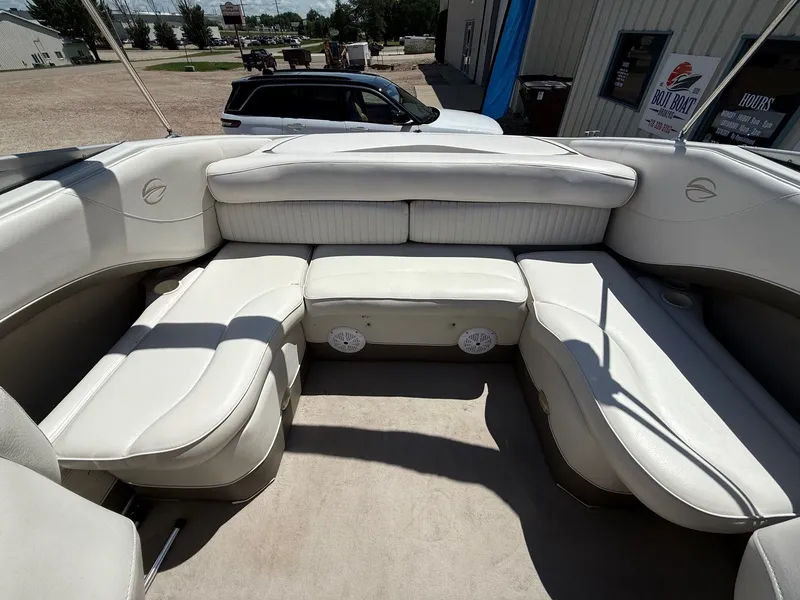 Slide: The Image of 2004 Crownline 266 BR boat interior with white seating and spacious layout. - 19