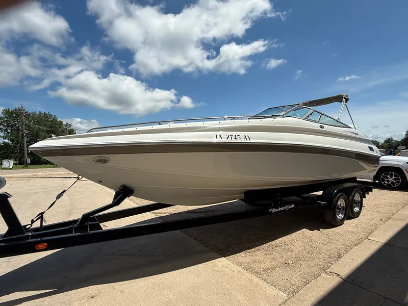 Slide: The Image of 2004 Crownline 266 BR boat on trailer under a clear blue sky. - 2