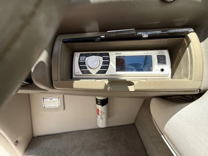 Slide: The Image of 2004 Crownline 266 BR boat interior with Pyle stereo system and fire extinguisher. - 24