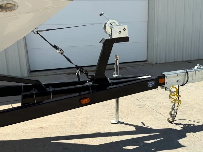 Slide: The Image of Trailer hitch of a 2004 Crownline 266 BR boat, parked on concrete. - 28