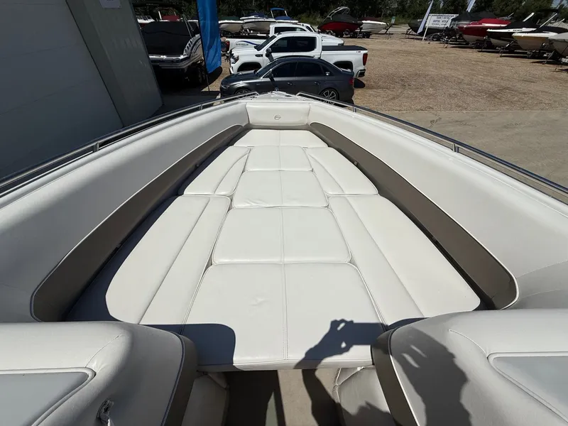 Slide: The Image of 2004 Crownline 266 BR boat with spacious white seating area. - 9