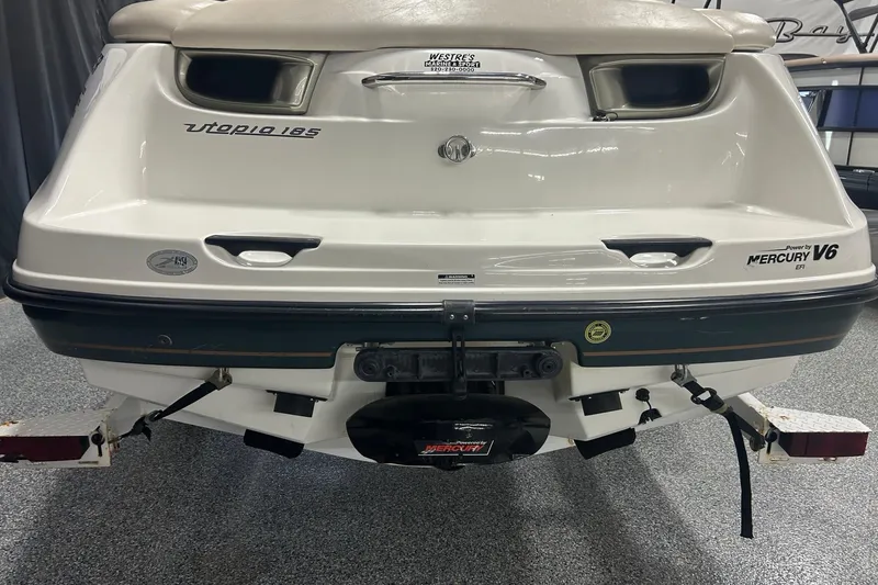 Slide: The Image of Rear view of a 2001 Sea-Doo Utopia 185 boat with Mercury V6 engine. - 12