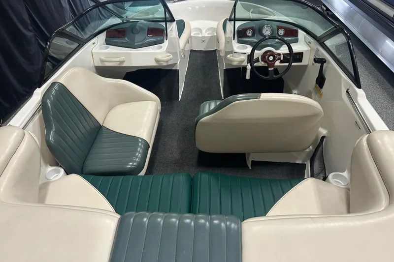 Slide: The Image of 2001 Sea-Doo Utopia 185 boat interior with green and white seating, steering wheel, and dashboard. - 5