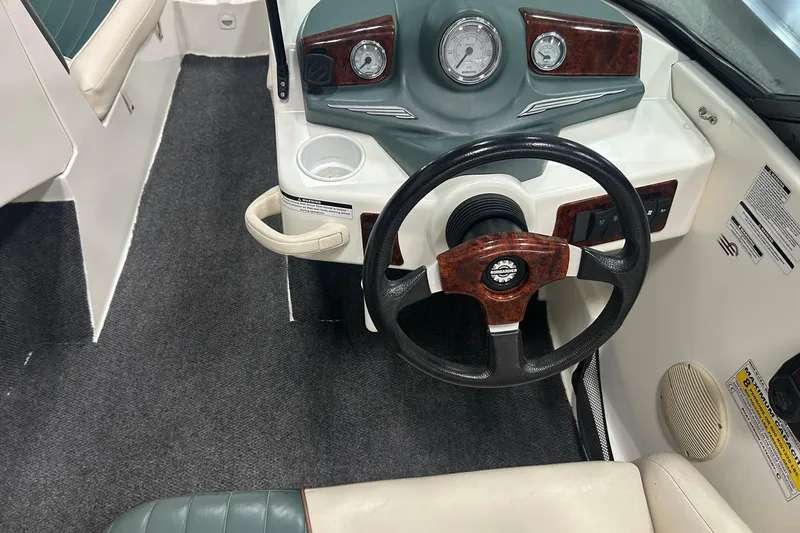Slide: The Image of 2001 Sea-Doo Utopia 185 boat dashboard with steering wheel and gauges. - 6