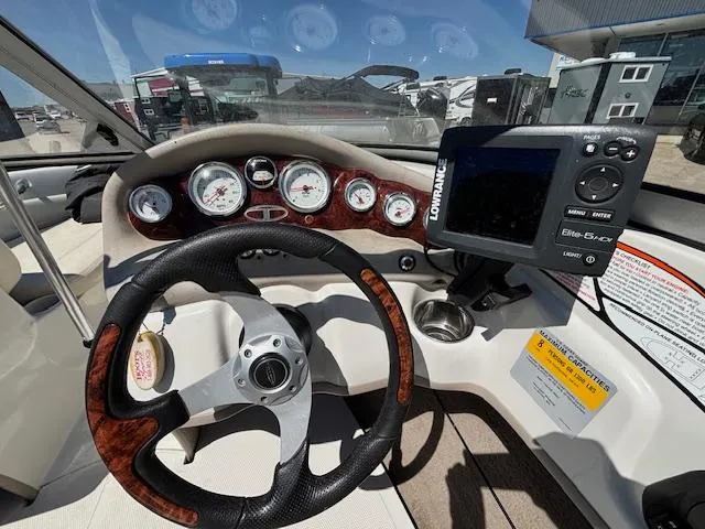 Slide: The Image of Steering wheel and dashboard of 2014 Tracker Tahoe Q5 boat with navigation system. - 10