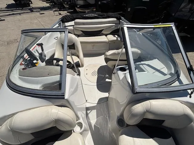 Slide: The Image of 2014 Tracker Tahoe Q5 boat interior with white seating and open windshield. - 14