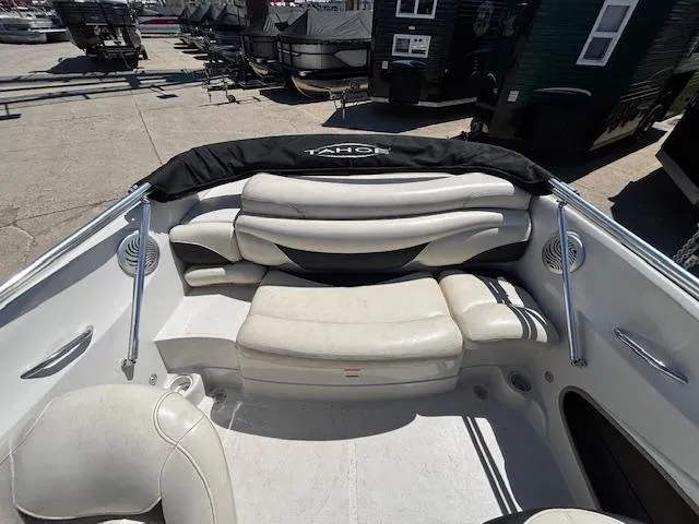 Slide: The Image of 2014 Tracker Tahoe Q5 boat interior with white seating and black cover. - 16