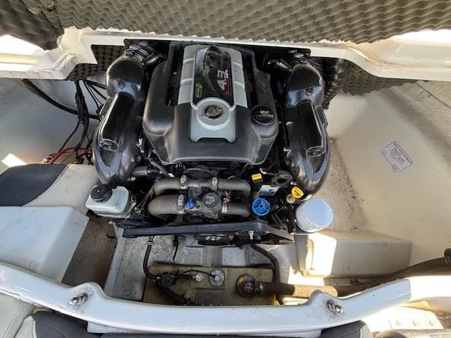 Slide: The Image of Engine compartment of a 2014 Tracker Tahoe Q5 boat, showcasing the motor and components. - 17