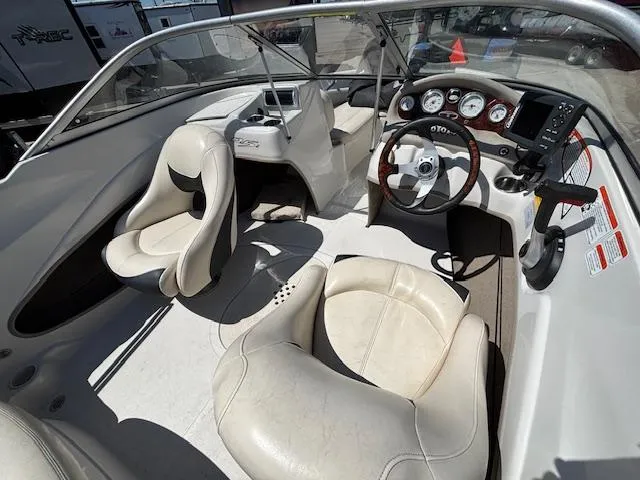 Slide: The Image of 2014 Tracker Tahoe Q5 boat interior with steering wheel and white seating. - 6