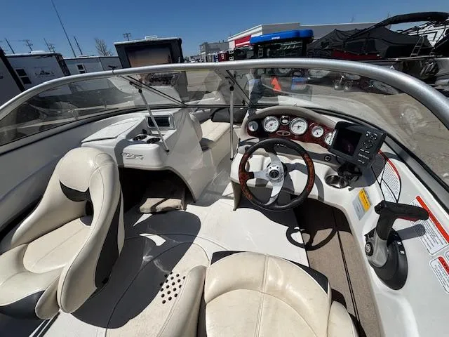 Slide: The Image of Interior of a 2014 Tracker Tahoe Q5 boat with steering wheel and dashboard controls. - 7