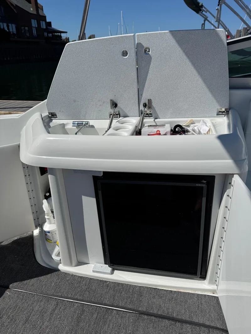 Slide: The Image of 1996 Formula 280 SS boat kitchenette with sink and storage compartments. - 23