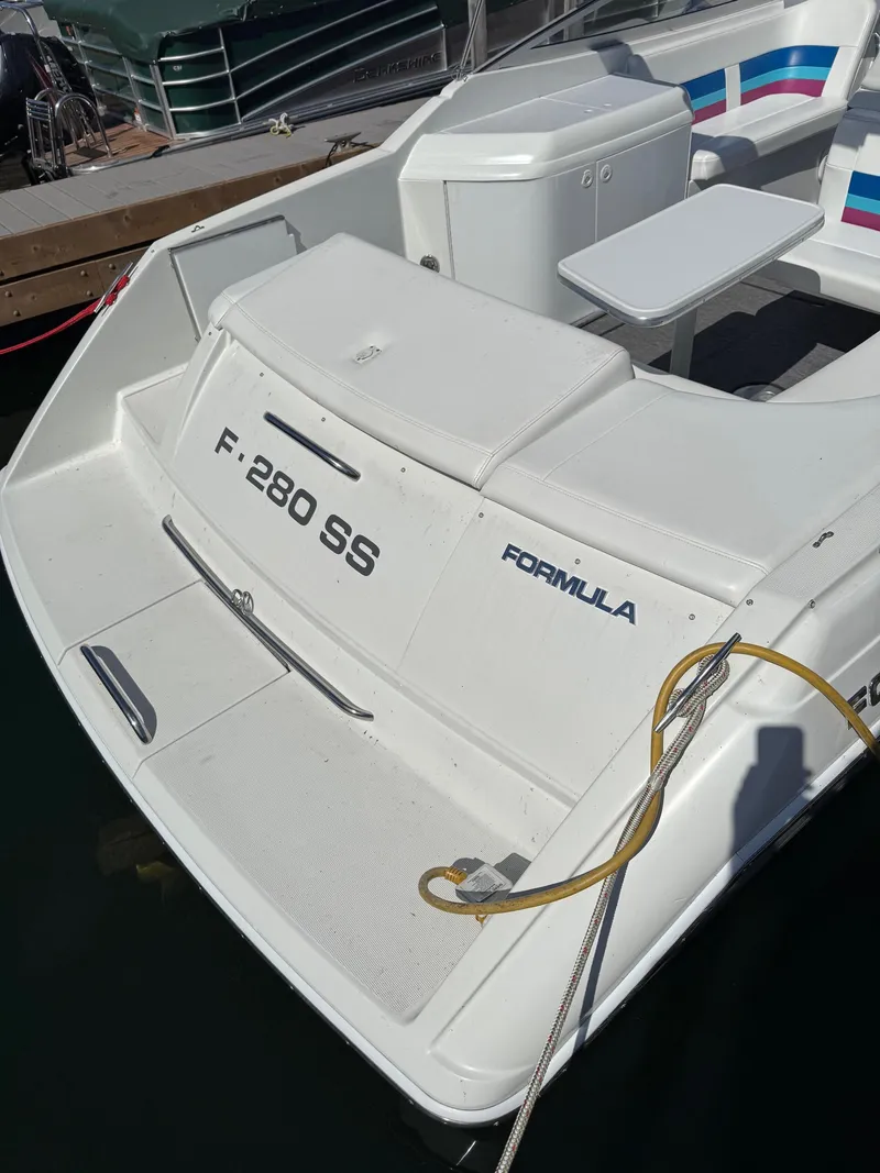 Slide: The Image of 1996 Formula 280 SS boat stern view with seating and table. - 24