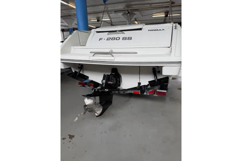Slide: The Image of 1996 Formula 280 Sun Sport boat on trailer, rear view in indoor storage. - 25