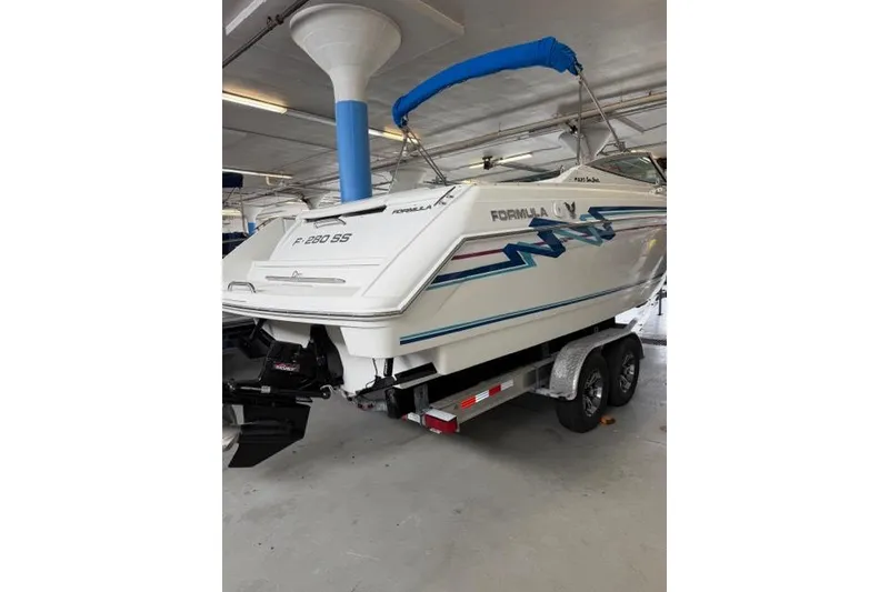 Slide: The Image of 1996 Formula 280 Sun Sport boat on trailer in indoor storage. - 26