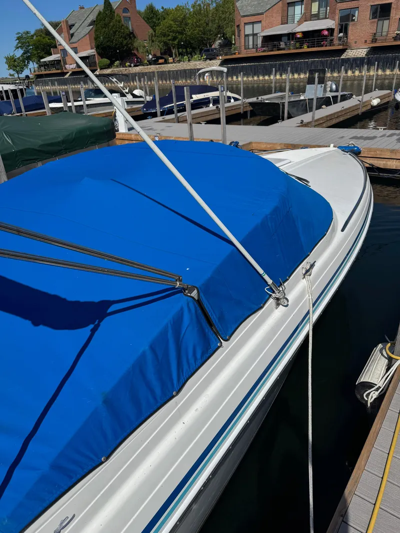 Slide: The Image of 1996 Formula 280 SS boat with blue cover docked at marina. - 3