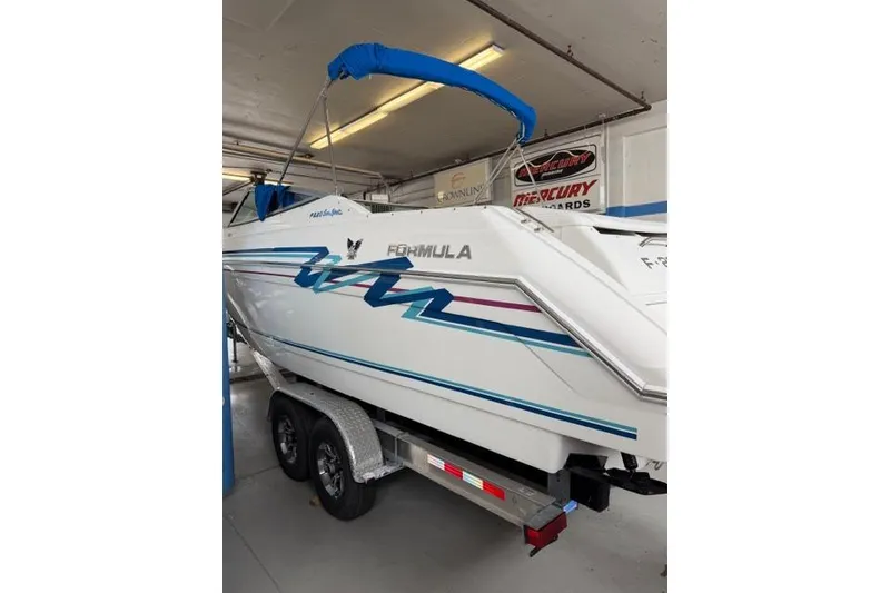 Slide: The Image of 1996 Formula 280 Sun Sport boat on trailer in garage setting. - 33