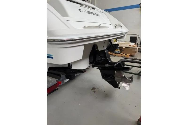 Slide: The Image of 1996 Formula 280 Sun Sport boat stern with propeller in a garage setting. - 34