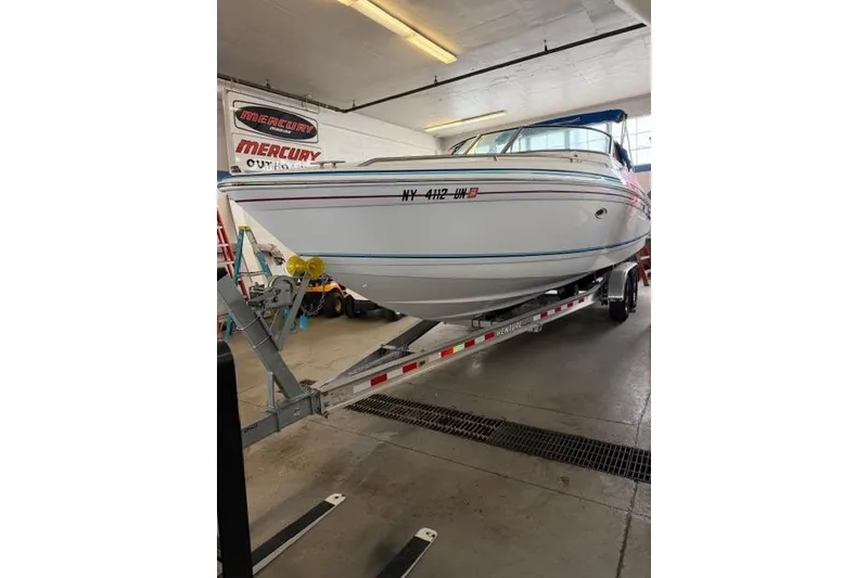 Slide: The Image of 1996 Formula 280 Sun Sport boat on trailer in indoor garage setting. - 35