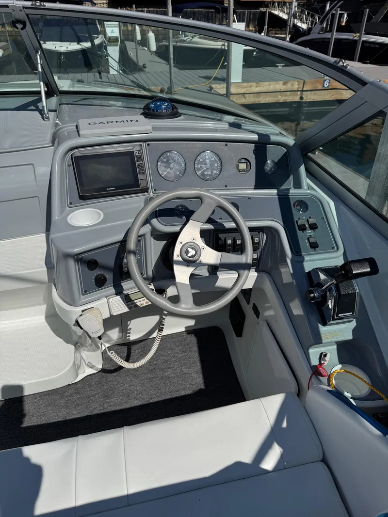Slide: The Image of 1996 Formula 280 SS boat cockpit with steering wheel, Garmin GPS, and control panel. - 5
