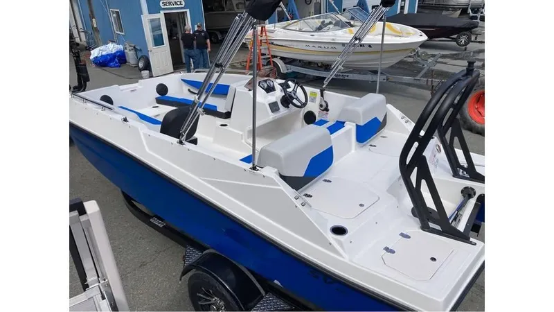 Slide: The Image of 2025 Starcraft SV 16 OB boat with blue and white design, docked at a marina. - 6