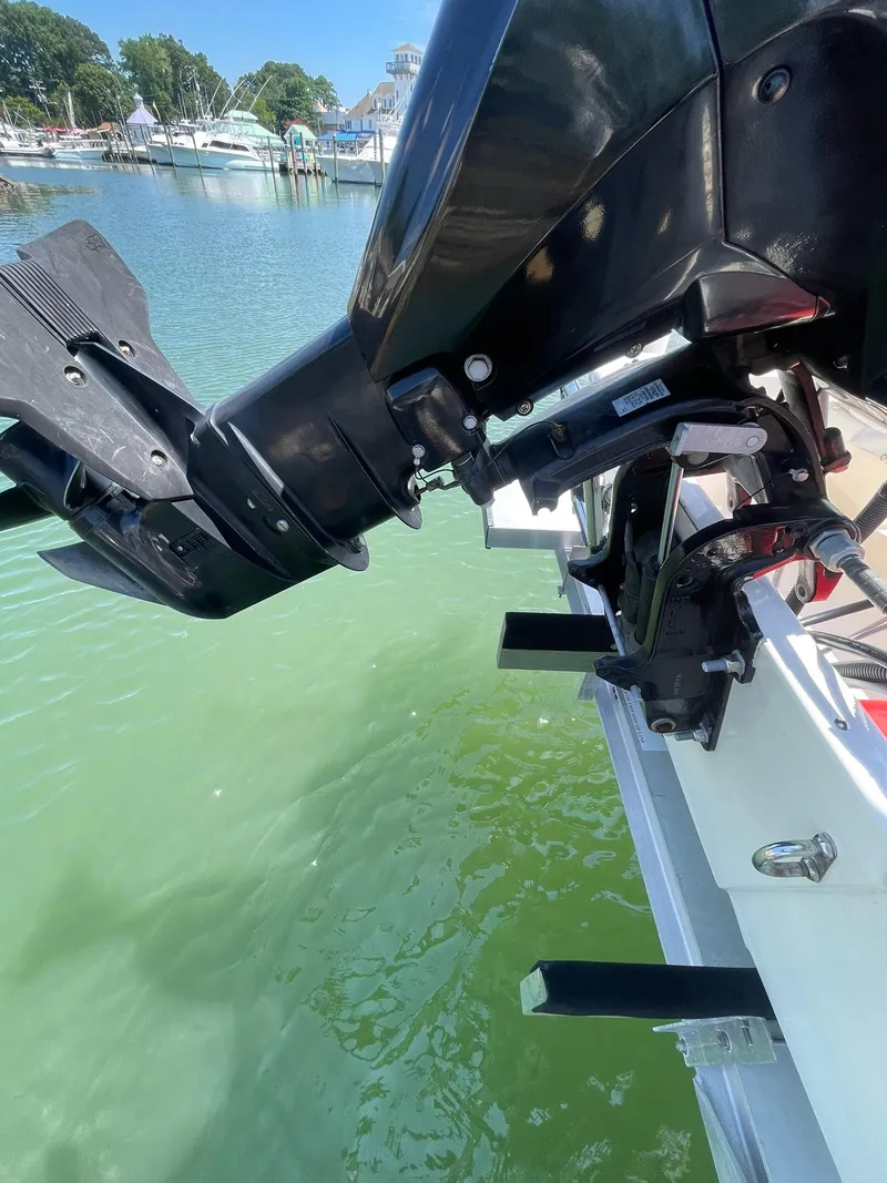 Slide: The Image of Boston Whaler 110 Sport 2015 outboard motor on calm water, docked at marina. - 18