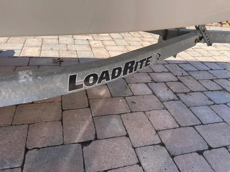 Slide: The Image of Trailer for 2015 Boston Whaler 110 Sport on Load Rite, brick pavement background. - 25