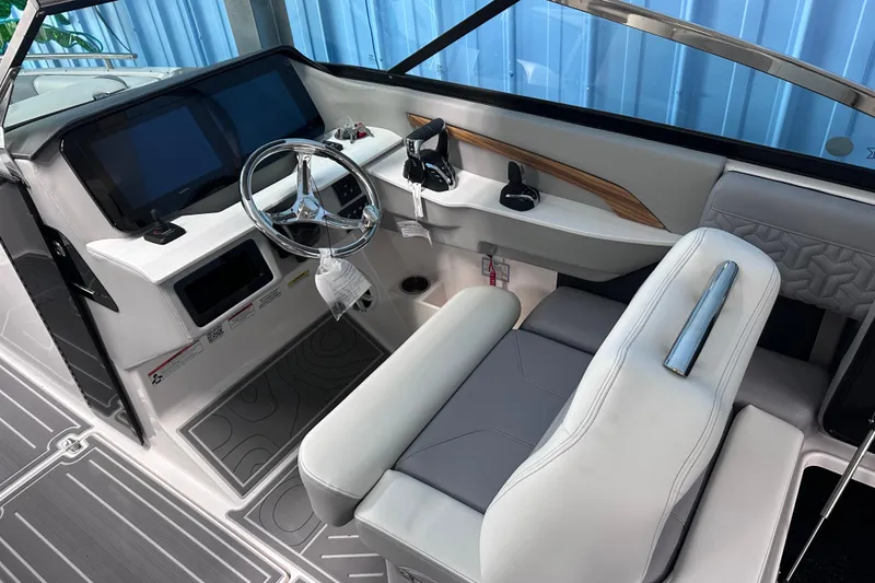 Slide: The Image of 2026 Regal LX9 boat cockpit with modern steering, dual screens, and luxurious seating. - 14