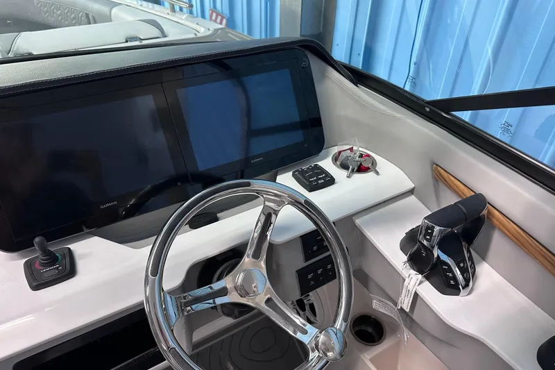 Slide: The Image of 2026 Regal LX9 boat dashboard with dual Garmin screens and modern controls. - 15