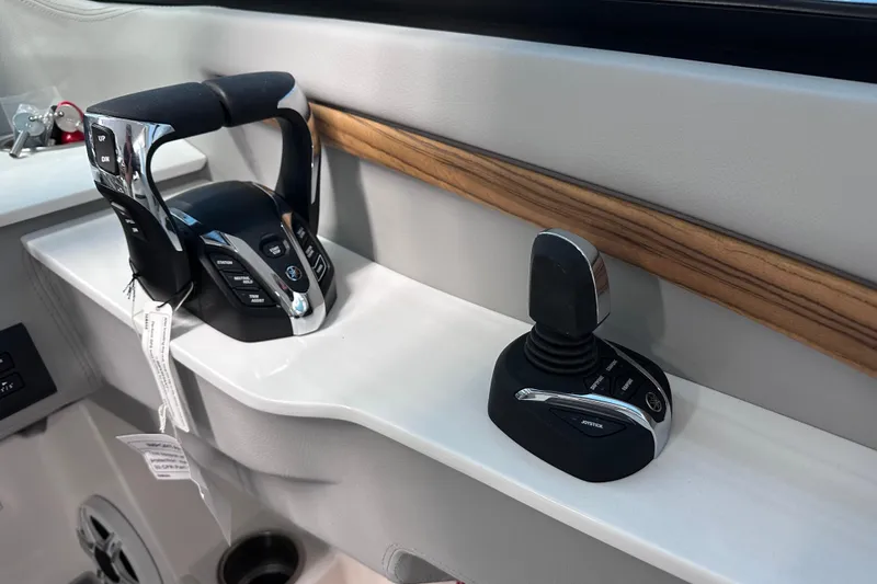 Slide: The Image of 2026 Regal LX9 boat controls with joystick and throttle on sleek dashboard. - 16