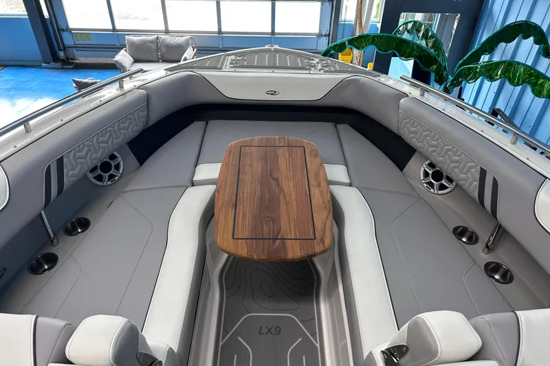 Slide: The Image of Luxurious 2026 Regal LX9 boat interior with elegant seating and wooden table. - 19