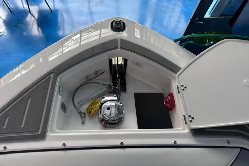 Slide: The Image of 2026 Regal LX9 boat anchor compartment with open hatch, showcasing storage and equipment. - 24