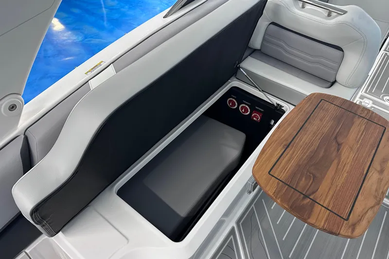 Slide: The Image of 2026 Regal LX9 boat interior with storage compartment and wooden table. - 9