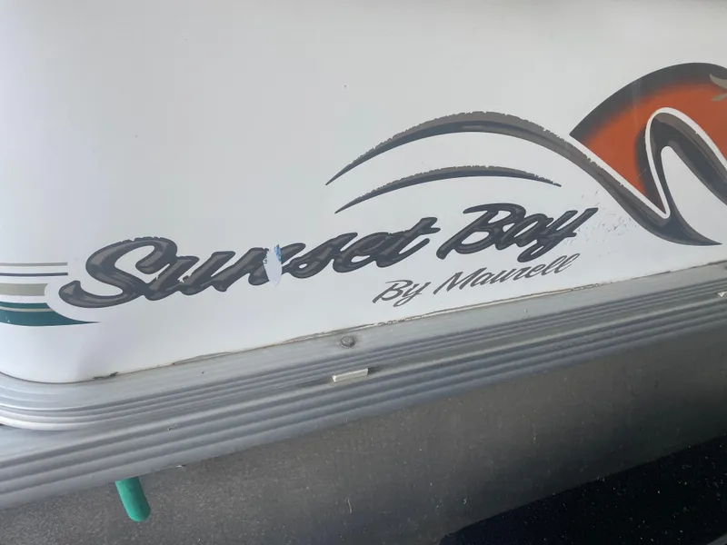 Slide: The Image of Sunset Bay Cruz 250 boat logo, 2008 model, featuring stylish design elements. - 2