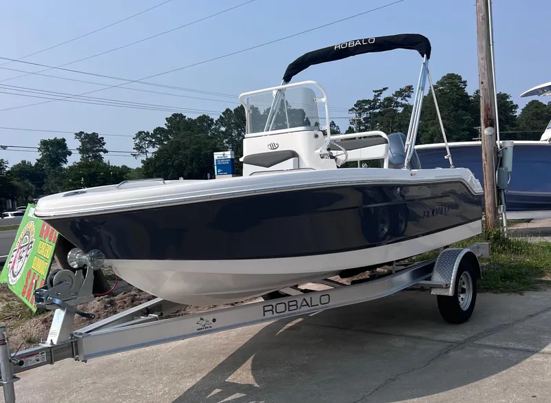 Slide: The Image of 2025 Robalo R160 Center Console boat on trailer, displayed outdoors. - 1
