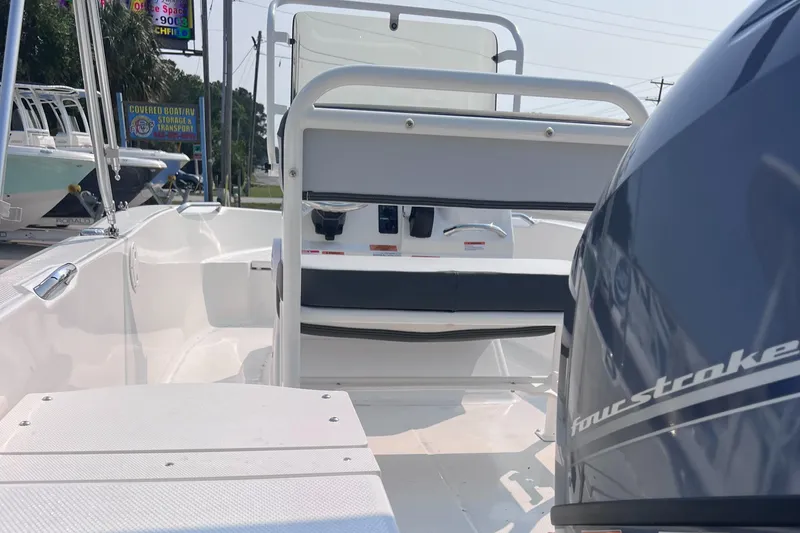 Slide: The Image of 2025 Robalo R160 Center Console boat interior with four-stroke engine, showcasing seating and controls. - 4