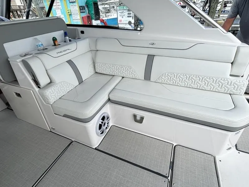 Slide: The Image of Luxurious seating on 2022 Regal LX36 boat, featuring elegant white upholstery and modern design. - 11