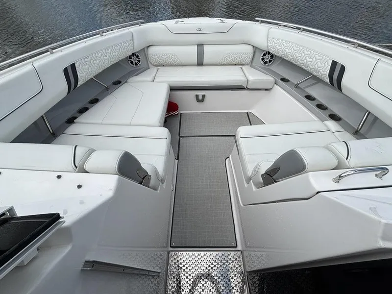 Slide: The Image of Luxurious seating area on a 2022 Regal LX36 boat, featuring elegant white upholstery. - 2