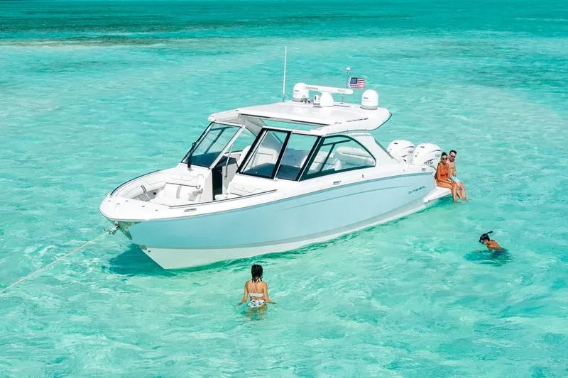 Slide: The Image of Manufacturer Provided Image: 2022 Regal LX36 boat in clear turquoise water with people swimming. - 24