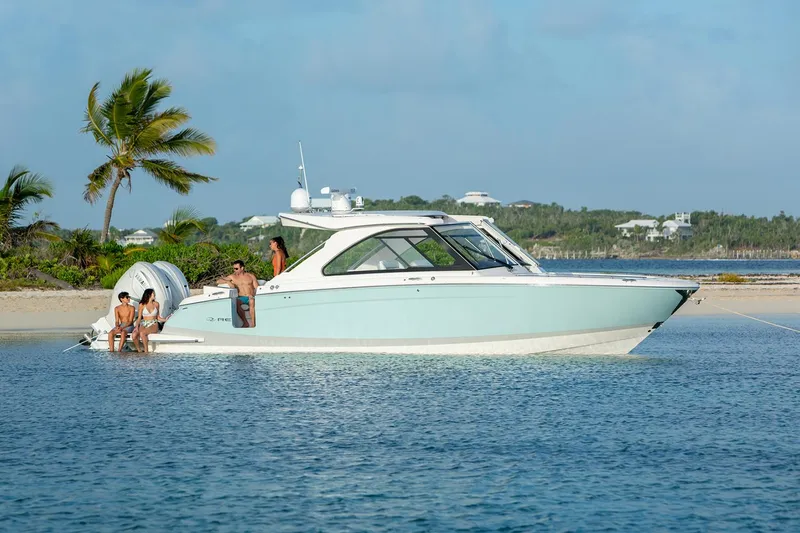 Slide: The Image of Manufacturer Provided Image: 2022 Regal LX36 boat anchored near a tropical beach with people relaxing. - 25