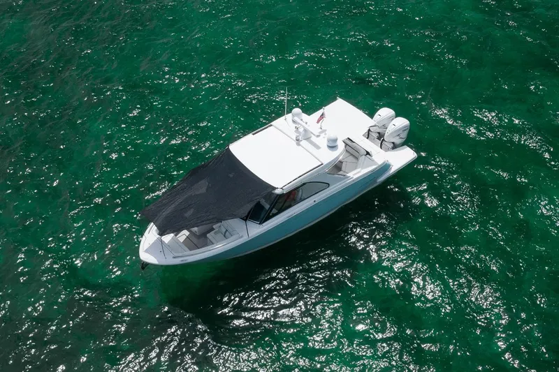Slide: The Image of Manufacturer Provided Image: Aerial view of 2022 Regal LX36 boat on clear green water. - 27