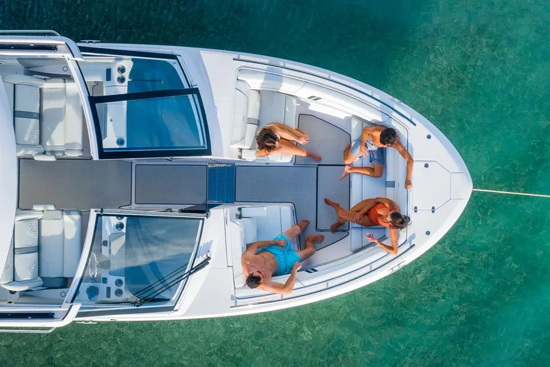 Slide: The Image of Manufacturer Provided Image: Aerial view of 2022 Regal LX36 boat with people relaxing on deck. - 28