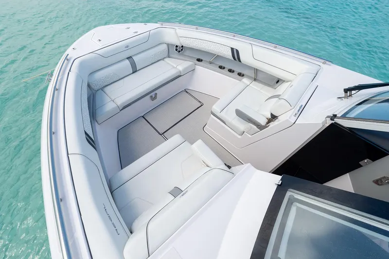 Slide: The Image of Manufacturer Provided Image: 2022 Regal LX36 boat interior with white seating and turquoise water. - 30