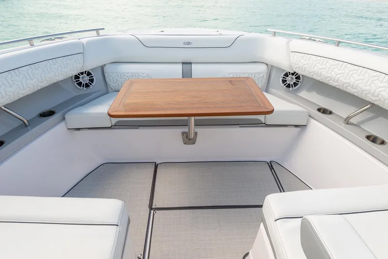 Slide: The Image of Manufacturer Provided Image: 2022 Regal LX36 boat interior with cushioned seating and wooden table. - 31